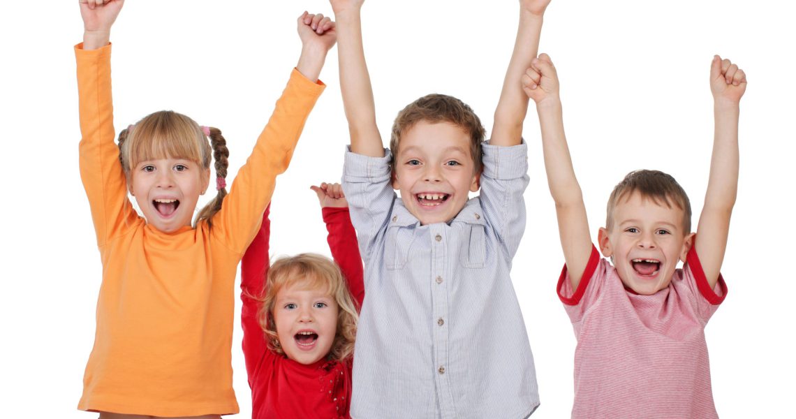 Happy kids with their hands up isolated on white